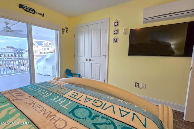 bedroom featuring a closet, access to outside, and a wall mounted AC