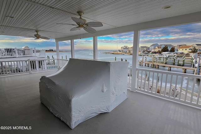 bedroom featuring ceiling fan and a water view