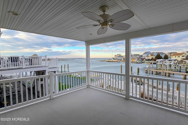 balcony with a water view and ceiling fan