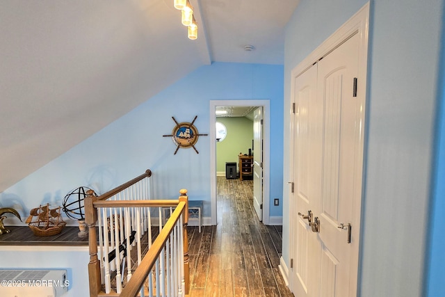 corridor featuring dark hardwood / wood-style flooring and lofted ceiling