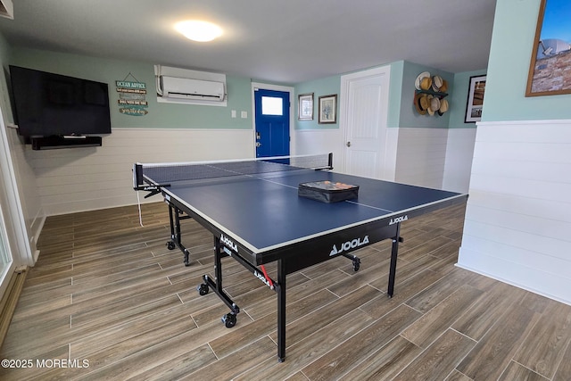 recreation room featuring a wall mounted air conditioner