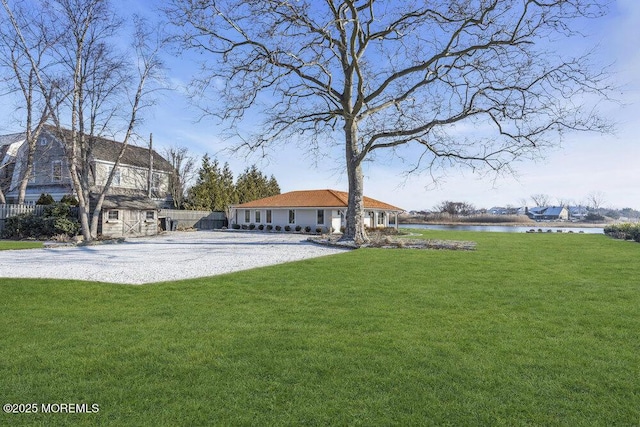 view of yard with a water view and a storage unit