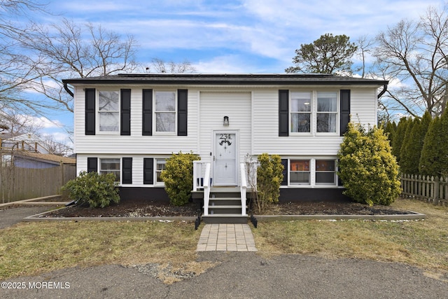 split foyer home with a front lawn