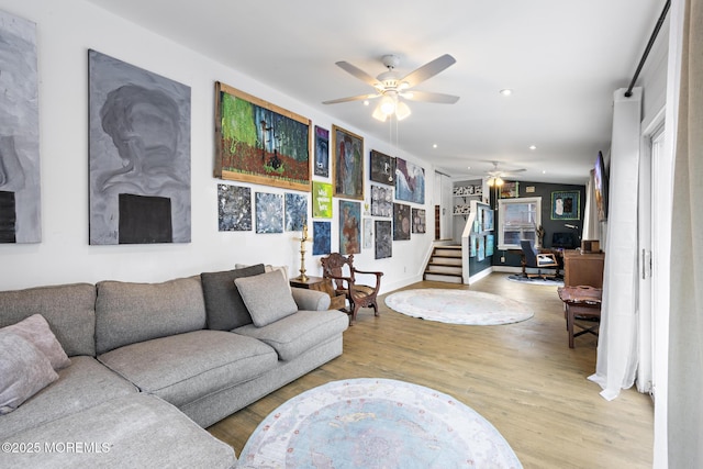 living room featuring ceiling fan and light hardwood / wood-style floors