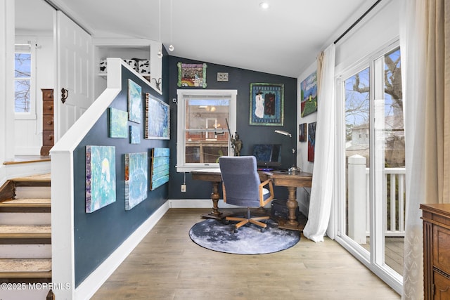 office with wood-type flooring, vaulted ceiling, and a wealth of natural light