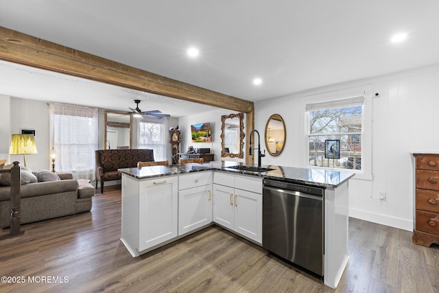 kitchen featuring dark wood-type flooring, dishwasher, white cabinets, dark stone countertops, and sink