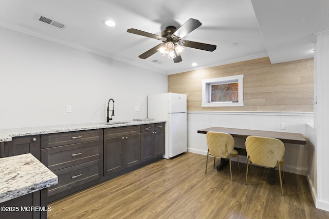 kitchen with sink, white refrigerator, light stone counters, and dark hardwood / wood-style floors