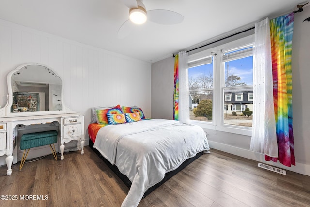 bedroom with ceiling fan and dark hardwood / wood-style flooring