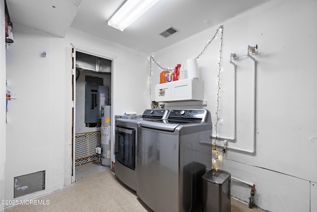 laundry room featuring gas water heater, light tile patterned flooring, independent washer and dryer, and electric panel