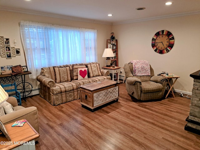 living room featuring hardwood / wood-style flooring and ornamental molding