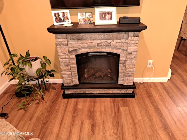 interior details with hardwood / wood-style flooring and a fireplace