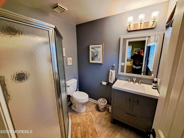 bathroom with vanity, toilet, and an enclosed shower