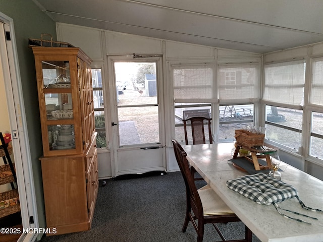 sunroom featuring lofted ceiling and plenty of natural light