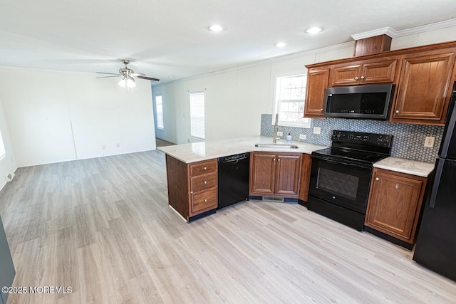 kitchen with black appliances, ceiling fan, ornamental molding, sink, and light hardwood / wood-style flooring