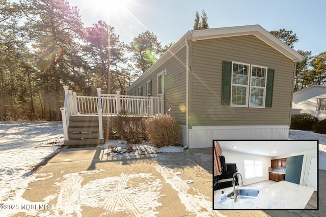 exterior space featuring sink and a wooden deck