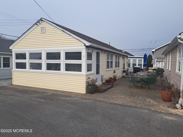 view of side of property with a patio area