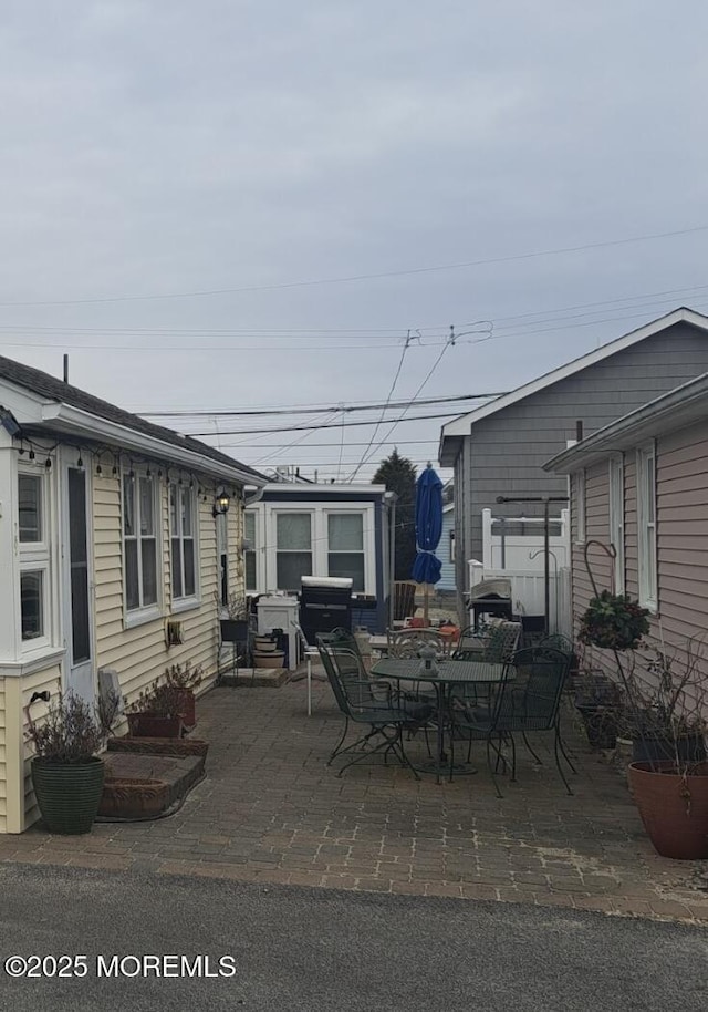 view of patio / terrace with grilling area and a shed