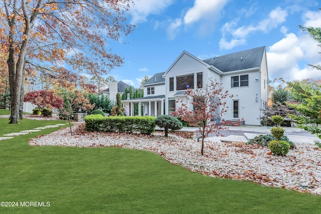 rear view of house with a lawn