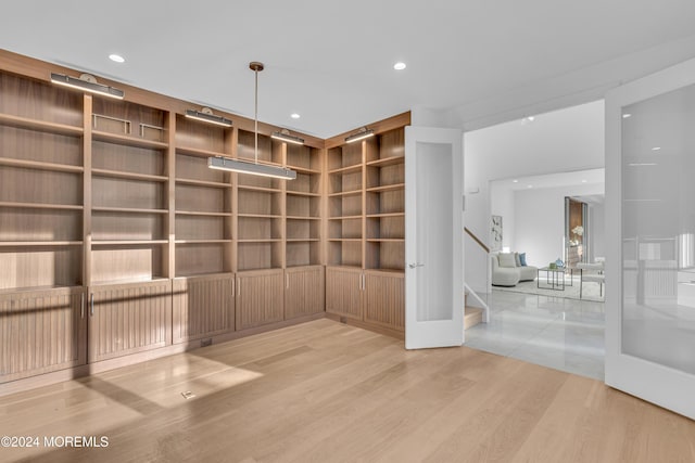 unfurnished room featuring light wood-type flooring and built in features