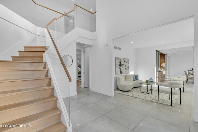 staircase featuring a high ceiling