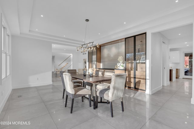 dining area featuring a chandelier and a tray ceiling