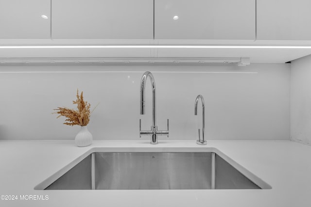 interior details with sink and white cabinets