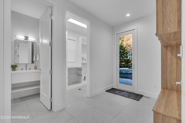 tiled foyer entrance with sink