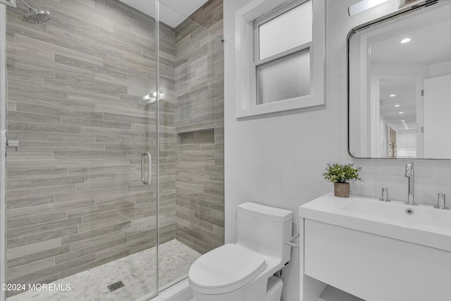 bathroom featuring toilet, walk in shower, decorative backsplash, tile walls, and vanity