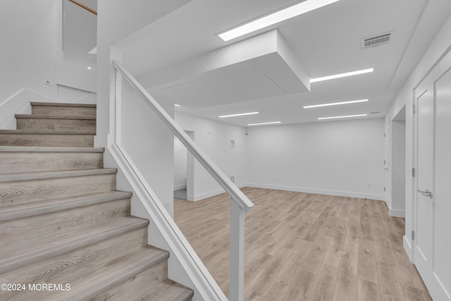 stairway featuring hardwood / wood-style floors