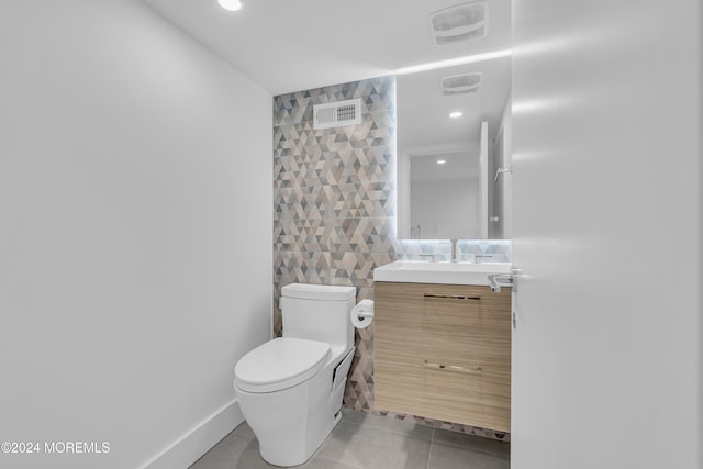 bathroom featuring tile walls, toilet, tile patterned floors, and vanity