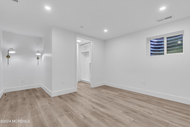 unfurnished room with light wood-type flooring