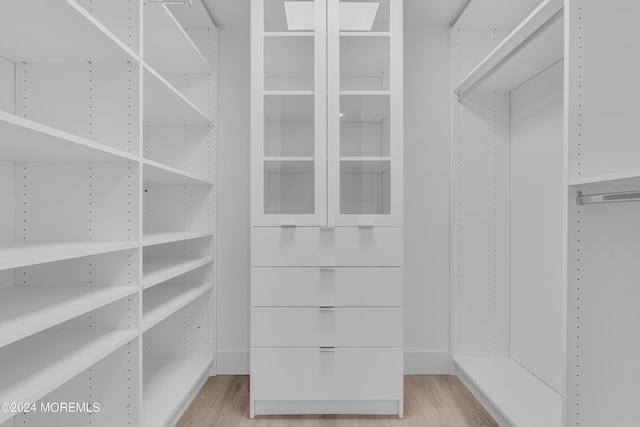 spacious closet with light hardwood / wood-style floors