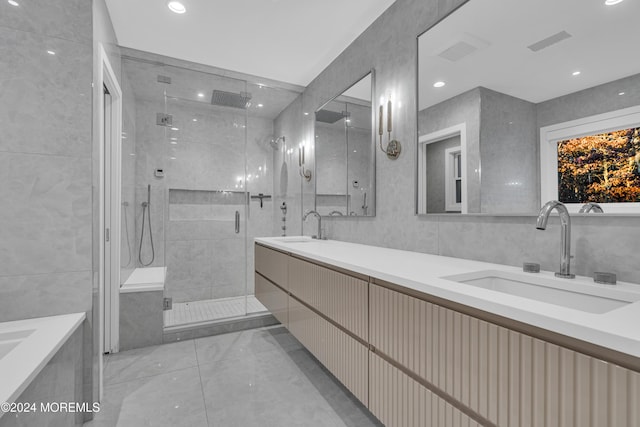 bathroom featuring vanity, tile walls, and walk in shower