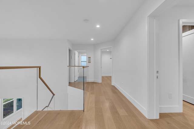 hallway with light hardwood / wood-style floors