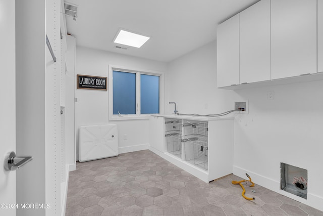 laundry area featuring hookup for a washing machine and cabinets