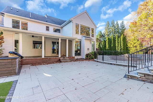 back of property with a porch and a patio area