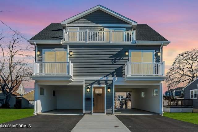 view of front facade featuring a balcony and a carport