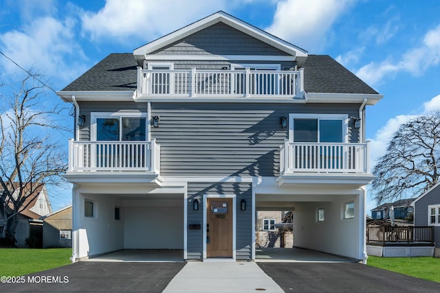 view of front of house with a balcony and a carport