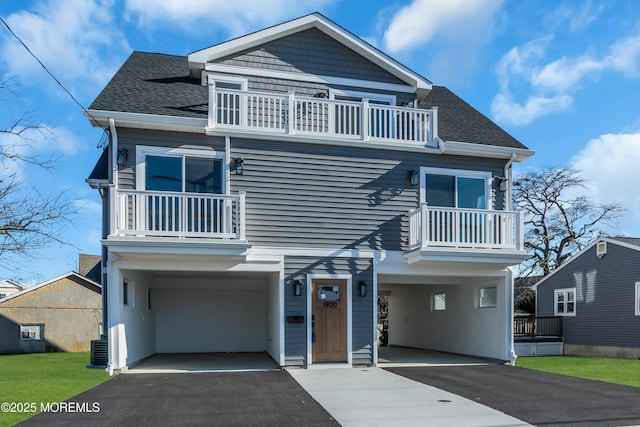 view of front of home with a balcony and a garage