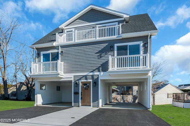 view of front of property with a carport and a balcony