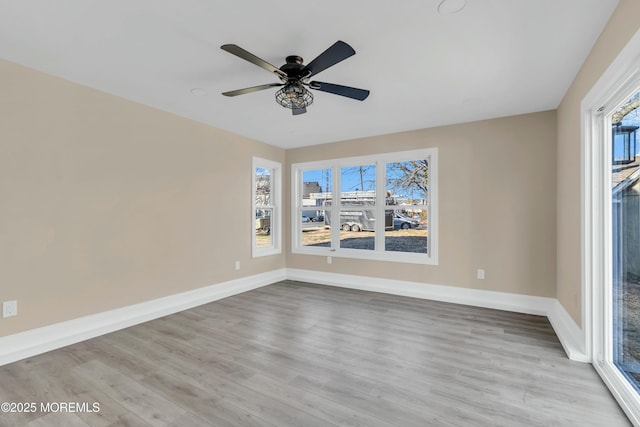 unfurnished room with ceiling fan, light hardwood / wood-style flooring, and a wealth of natural light