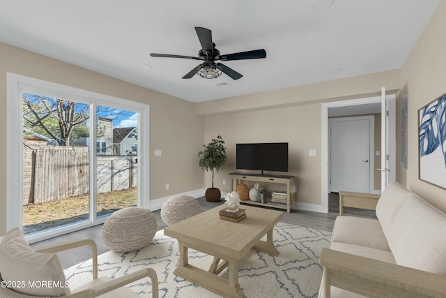 living room featuring ceiling fan and light wood-type flooring