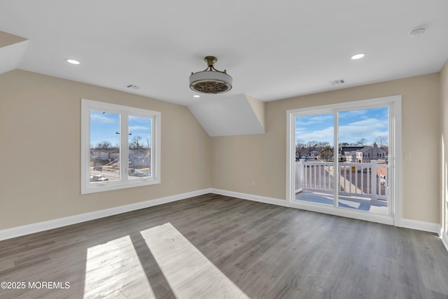 additional living space with lofted ceiling and wood-type flooring