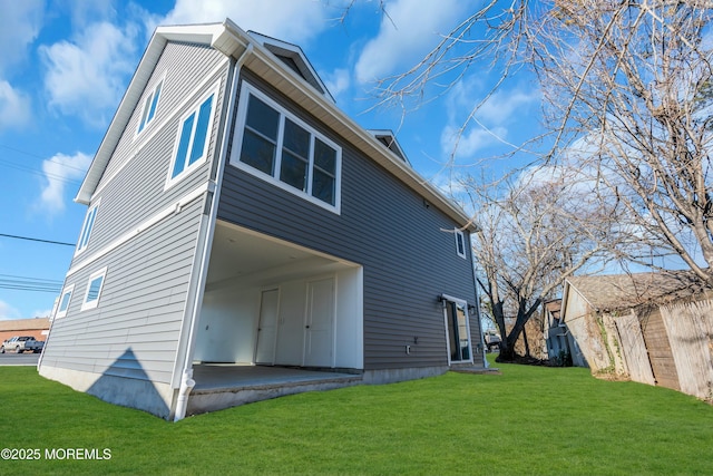 rear view of property with a yard