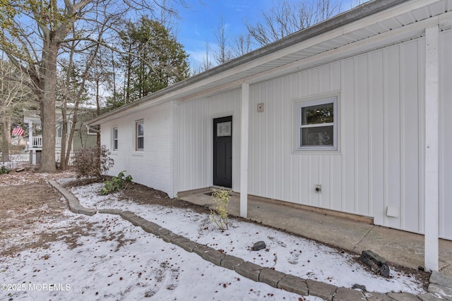 view of snow covered property entrance