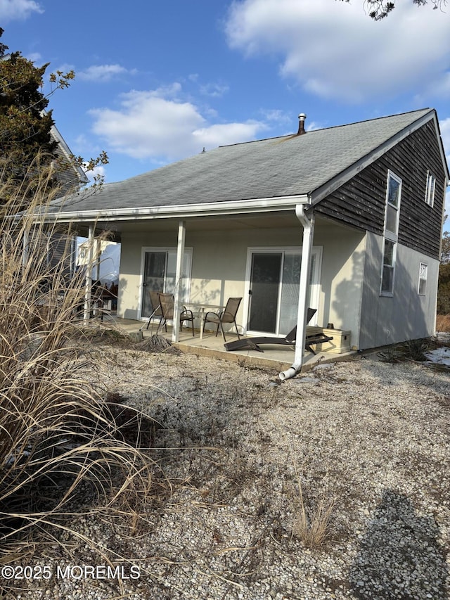 back of property with a patio