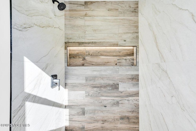 bathroom with a tile shower