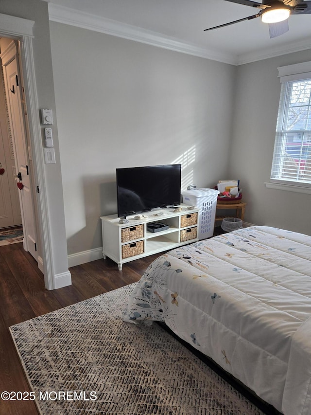 bedroom with ceiling fan, dark hardwood / wood-style flooring, and ornamental molding