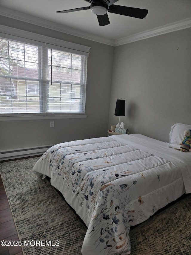 bedroom featuring ceiling fan, dark hardwood / wood-style flooring, crown molding, and a baseboard heating unit