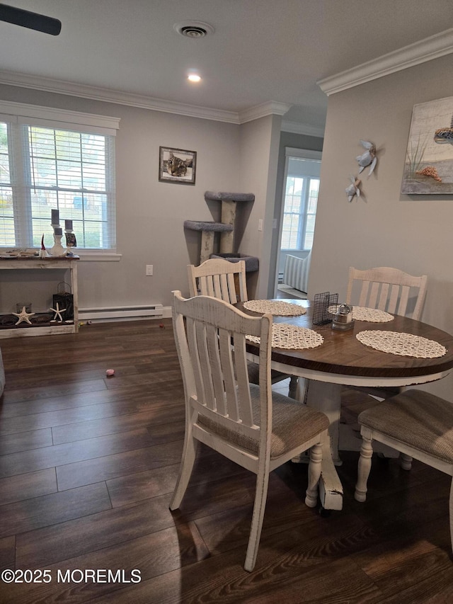 dining room featuring baseboard heating, crown molding, and dark hardwood / wood-style floors